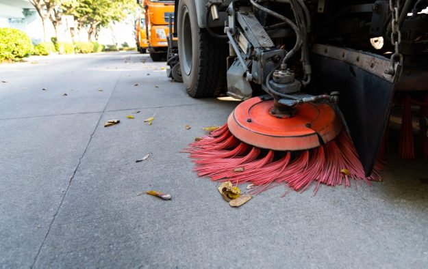 Street sweepers are cleaning city street